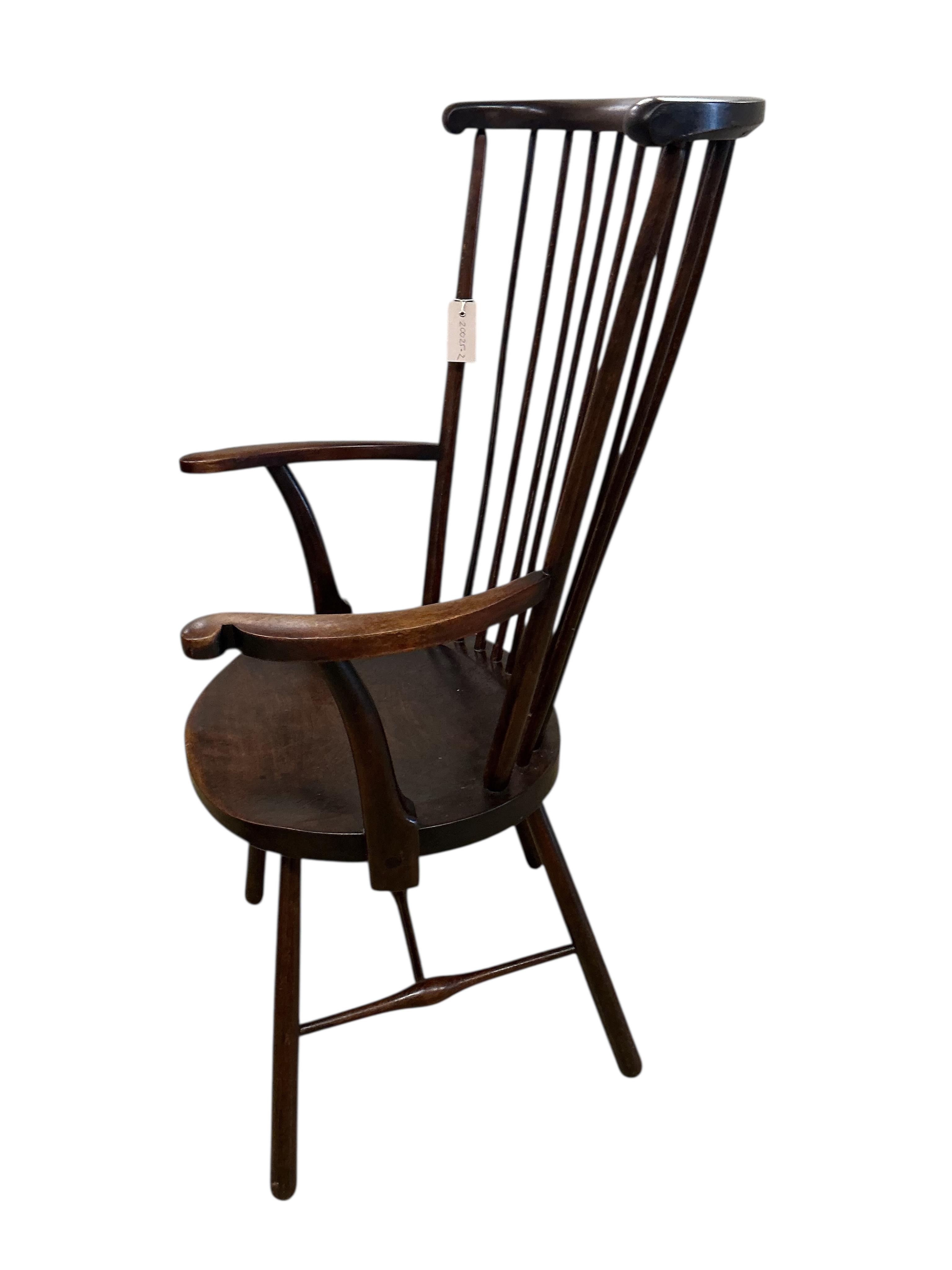 An Arts & Crafts Liberty style Windsor comb back armchair, width 59cm, depth 43cm, height 109cm